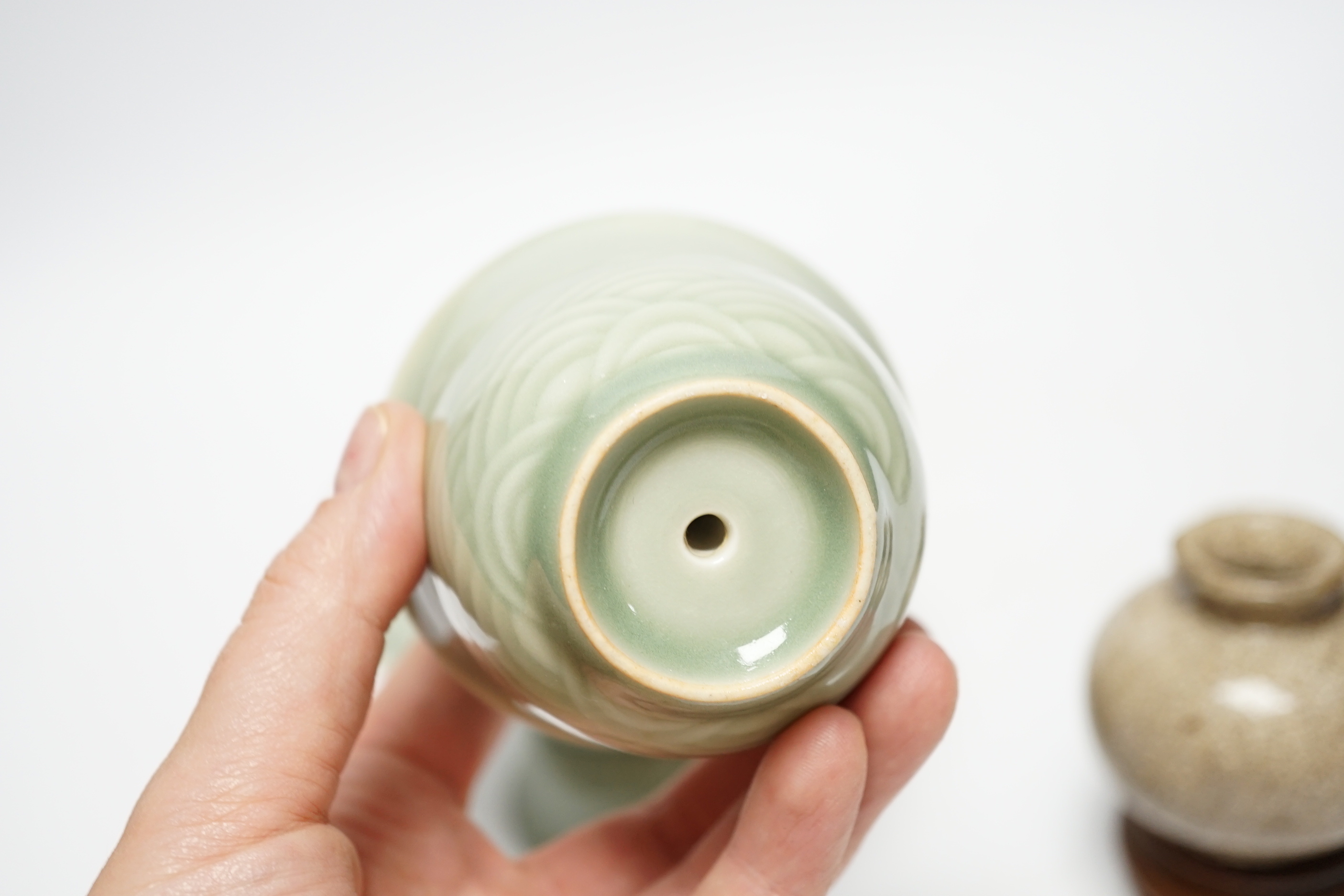 A Chinese celadon glazed 'dragon' puzzle cup and stand, early 20th century and a Chinese crackle glaze vase, 19th century, cup 7.5cm